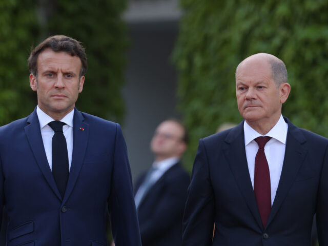 BERLIN, GERMANY - MAY 09: German Chancellor Olaf Scholz (R) and French President Emmanuel Macron review a guard of honour upon Macron's arrival for talks at the Chancellery on May 09, 2022 in Berlin, Germany. High on the agenda for the two leaders is the ongoing Russian war in Ukraine …