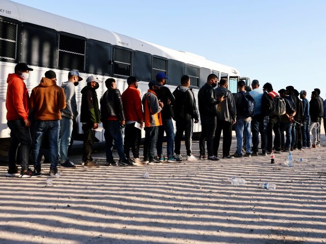 YUMA, ARIZONA - MAY 19: Immigrants wait to board a U.S. Border Patrol bus to be taken for