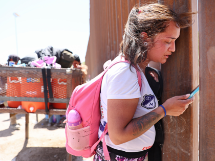 An immigrant mother from Colombia speaks by phone while notifying a family member in Colombia that she crossed the U.S.-Mexico border barrier with her daughter and cousins on May 20, 2022 in Yuma, Arizona. Title 42, the controversial pandemic-era border policy enacted by former President Trump, which cites COVID-19 as …