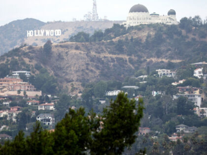 LOS ANGELES, CALIFORNIA - AUGUST 04: Homes stand beneath Griffith Observatory and the Holl