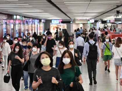 HONG KONG, CHINA - AUGUST 25: Commuters wear face masks at a MTR station on August 25, 202