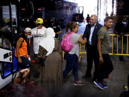 NEW YORK, NEW YORK - AUGUST 25: New York Immigrant Affairs Commissioner Manuel Castro (2R) gives a welcome to migrants who arrived from Texas at Port Authority Bus Terminal on August 25, 2022 in New York City. This Thursday more than 200 migrants are coming to NYC. This is after …
