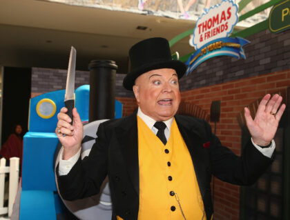 MELBOURNE, AUSTRALIA - MARCH 05: Bert Newton, dressed as The Fat Controller, is seen with a Thomas the Tank birthday cake to help celebrate the Thomas & Friends 70th Birthday Celebration at Flinders Street Station on March 5, 2015 in Melbourne, Australia. (Photo by Robert Cianflone/Getty Images)