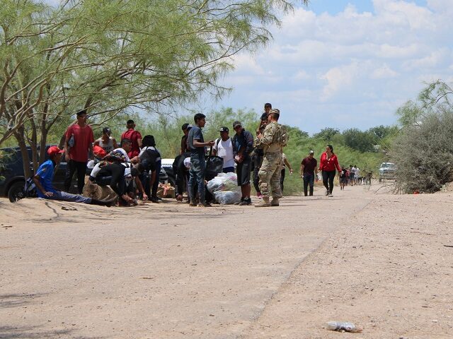 A group of migrants surrender to Texas National Guard Soldiers near Eagle Pass, Texas. (Ra