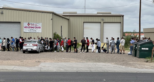 A group of migrants line up outside the Mission Hope Shelter in Eagle Pass, Texas, after being released by Border Patrol agents. (Randy Clark/Breitbart Texas)