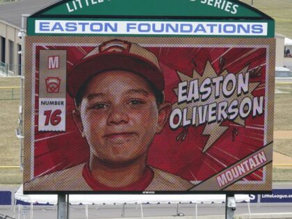 A picture of Mountain Region Champion Little League team member Easton Oliverson, from Santa Clara, Utah, is shown on the scoreboard at Volunteer Stadium during the opening ceremony of the 2022 Little League World Series baseball tournament in South Williamsport, Pa., Wednesday, Aug 17, 2022. Oliverson was injured when he …