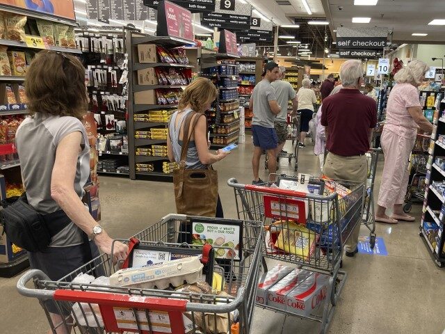 In this Thursday, Aug. 25, 2022, photograph, shoppers queue up in long lines to check out their items at a King Soopers grocery store in southeast Denver. (David Zalubowski/AP)