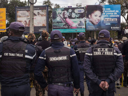 Madagascar police watch over opposition supporters close to former President Marc Ravalomanana as they attempt to gather for a protest in downtown Antananarivo on July 23, 2022. - Police in Madagascar detained two leading members of the main opposition party on Saturday during a protest against rising living costs and …