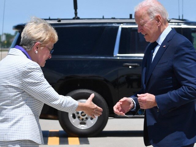 President Joe Biden shakes hands with Congresswoman Marcy Kaptur (D-OH) as he arrives at C
