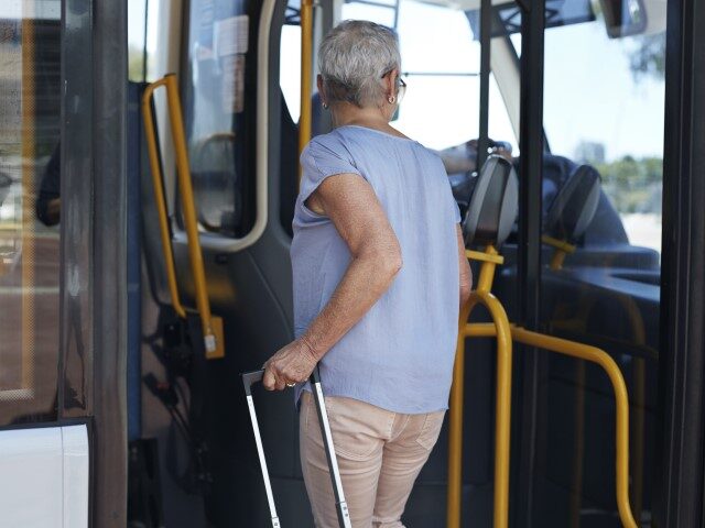 Mature woman boards bus