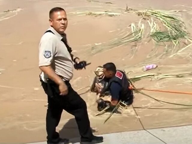 A Mexican firefighter pulls the lifeless body of a five-year-old Guatemalan girl from the Rio Grande near Juarez. (Canal44 Video Screenshot)