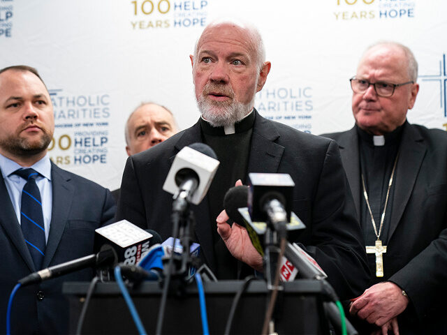 NEW YORK, NY - APRIL 11: Flanked by New York City Council Speaker Corey Johnson (L) and Archbishop of New York Timothy Dolan (R), Monsignor Kevin Sullivan (C), director of Catholic Charities of New York, speaks on during a press briefing about immigration and border issues at the offices of …