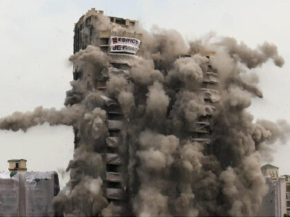 NEW DELHI, INDIA - 2022/08/28: Supertech build Apex and Ceyane 100-metre-high illegal residential Twin Towers demolished in 9 seconds in Noida Sector 93A. Over 3,700 Kg of explosives were infused into the two towers. The Two towers have a built-up area of around 7.5 lakh square feet. The tallest height …