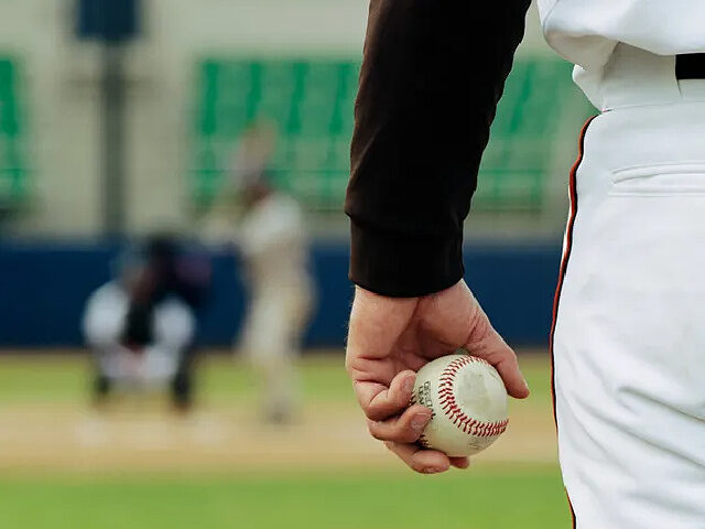 Pitcher on Mound Holding Baseball - stock photo