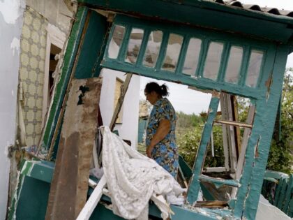 Valentyna Kondratieva, 75, walks into her damaged home Saturday, Aug. 13, 2022, where she sustained injuries in a Russian rocket attack last night in Kramatorsk, Donetsk region, eastern Ukraine. The strike killed three people and wounded 13 others, according to the mayor. The attack came less than a day after …