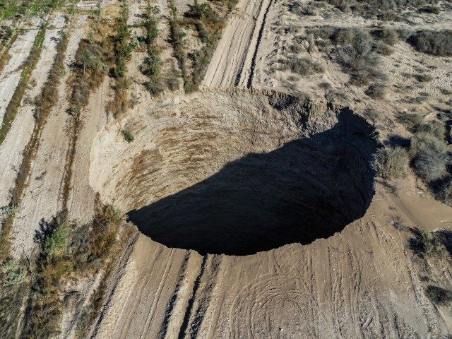 TOPSHOT-CHILE-MINING-SINKHOLE Aerial view taken on August 1, 2022, showing a large sinkhole that appeared over the weeke