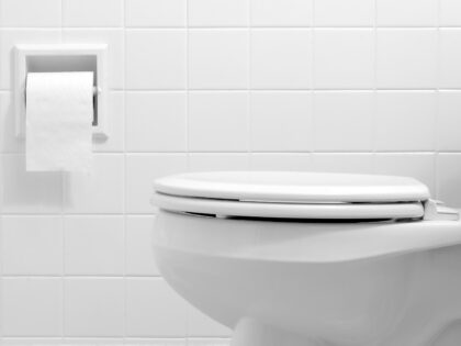 Clean, white bathroom toilet with the lid closed - stock photo (Getty)