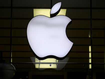 The logo of Apple is illuminated at a store in the city center in Munich, Germany, Wednesd