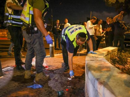 Zaka volunteers, an Ultra-Orthodox Jewish emergency response team, clean up blood stains after an attack outside Jerusalem's Old City, August 14, 2022. - Israeli police said they had arrested a suspect in a pre-dawn gun attack on a bus in central Jerusalem that wounded eight people according to an updated …