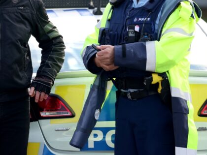 AUCKLAND, NEW ZEALAND - OCTOBER 02: Destiny Church leader Brian Tamaki (L) speaks with a police officer before leading a procession of motorbikes along the Southern Motorway towards the Auckland Domain for an anti-lockdown protest on October 02, 2021 in Auckland, New Zealand. Anti-vaccination activists have organised rallies across New …