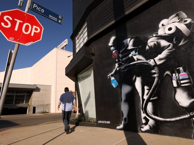 LOS ANGELES, CA - MARCH 9, 2021 - - A mural depicts a pair of men ready to battle COVID ar