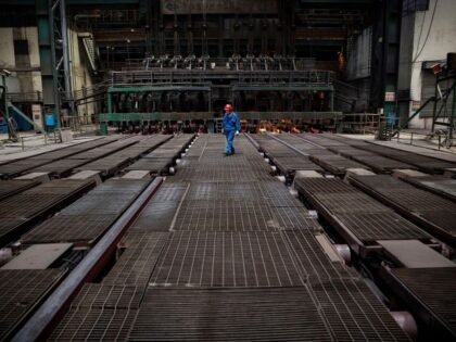CHANGZHOU, CHINA - MAY 12: A worker supervises the production of steel bar on the line at the Zhong Tian (Zenith) Steel Group Corporation on May 12, 2016 in Changzhou, Jiangsu. Zhong Tian (Zenith) Steel Group Corporation is a privately-owned manufacturer that employs over 13,000 workers at its facility in …