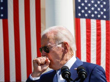 WASHINGTON, DC - AUGUST 9: U.S. President Joe Biden coughs while speaking before signing t