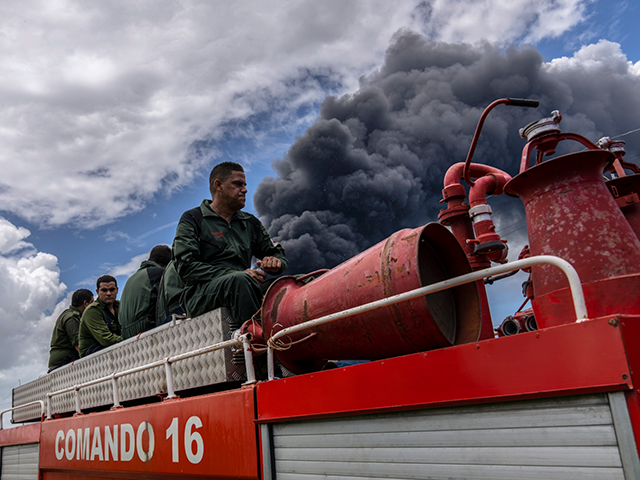 Firefighters move in a truck inside the Matanzas supertanker base to douse a fire that sta