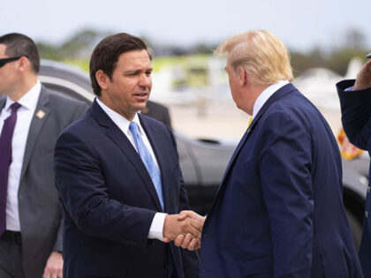 Gov. Ron DeSantis, R-Fla., greets President Donald Trump as he steps off Air Force One upo