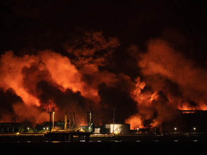 Flames and smoke rise from a massive fire at a fuel depot sparked by a lightning strike in Matanzas, Cuba, early on August 8, 2022. - Aircraft, firefighters and specialists from Mexico and Venezuela arrived in Cuba on August 7 to help put out a massive fire at a fuel …