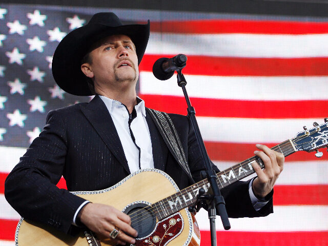 NEW YORK - NOVEMBER 11: (AFP OUT) John Rich performs before President George W. Bush takes the podium at a Veterans Day event at the Intrepid Sea-Air-Space Museum November 11, 2008 in New York City. President Bush formally rededicated the newly-refurbished USS Intrepid and museum in honor of Veterans Day. …