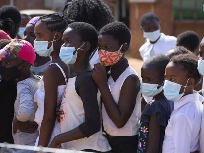 Children wear face masks while attending a social event in Epworth, Harare, in this Friday, June, 11, 2021 photo. Zimbabwe has opened up COVID-19 vaccination to the majority of teen children, while also allowing fully vaccinated people to eat in restaurants as a devastating third wave recedes and previously hesitant …