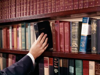 1960s MAN HAND REACHING BIBLE LIBRARY BOOKS (Photo by H. Armstrong Roberts/ClassicStock/Getty Images)