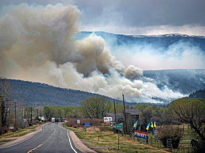 A flare up near Cleveland, just down 519 from Mora, N.M., darkens the sky on Wednesday, May 4, 2022, where firefighters have been battling the Hermit's Peak and Calf Canyon fire for weeks. New Mexico residents are suing the U.S. Forest Service for information on a massive wildfire that's been …