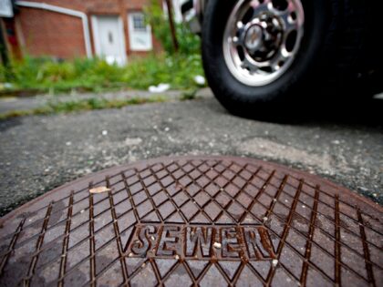 UNITED STATES - AUGUST 13: The cover of a private cesspool reads "Sewer" outside a business on Main Street in Southampton, New York, U.S., on Thursday, Aug. 13, 2009. Mark Epley, mayor of Southampton, is pushing for the installation of a sewer system in the business district of Southampton Village, …