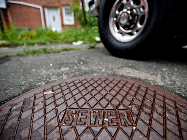 UNITED STATES - AUGUST 13: The cover of a private cesspool reads "Sewer" outside a busines