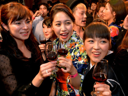 People toast the 2013 vintage Beaujolais Nouveau wine in Tokyo on November 21, 2013 after the embargo on the wine was removed at midnight. A total of eight million bottles of Beaujolais Nouveau wine are expected to be imported into Japan this year. AFP PHOTO / Yoshikazu TSUNO (Photo credit …