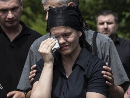KREMENCHUK, POLTAVA PROVINCE, UKRAINE, JUNE 30: (EDITOR'S NOTE: Image depicts death) Relatives mourn during a funeral ceremony at Potoky village for a civilian Andry Volodimirovic (42) killed at Amstor shopping mall targeted by Russian missile strike in Kremenchuk,Poltava Province, Ukraine on June 30, 2022 (Photo by Metin Aktas/Anadolu Agency via …
