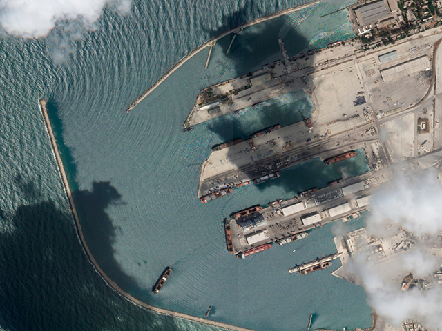 This satellite image from Planet Labs PBC shows the Sierra Leone-flagged cargo ship Razoni, center bottom with four white cranes on its red deck, at port in Tartus, Syria, Monday, Aug. 15, 2022. The first shipment of grain to leave Ukraine under a wartime deal has ended up in Syria, …