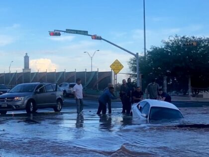 Watch: Firefighters, Good Samaritans Rescue Woman from Car Submerged in Sinkhole in El Paso, Texas