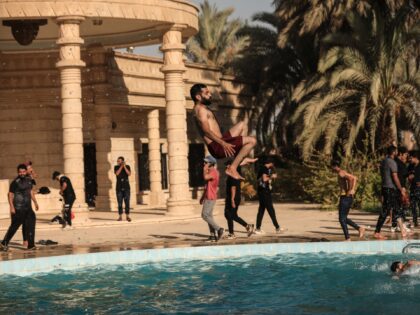 29 August 2022, Iraq, Baghdad: A supporter of Shiite cleric Muqtada Al-Sadr jumps in the p