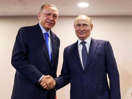 In this handout photo provided by the Turkish Presidency, Turkish President Recep Tayyip Erdogan, left, shakes hands with Russian President Vladimir Putin during their meeting, in Tehran, Iran, July 19, 2022.