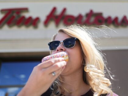 woman eating a Tim Hortons donut