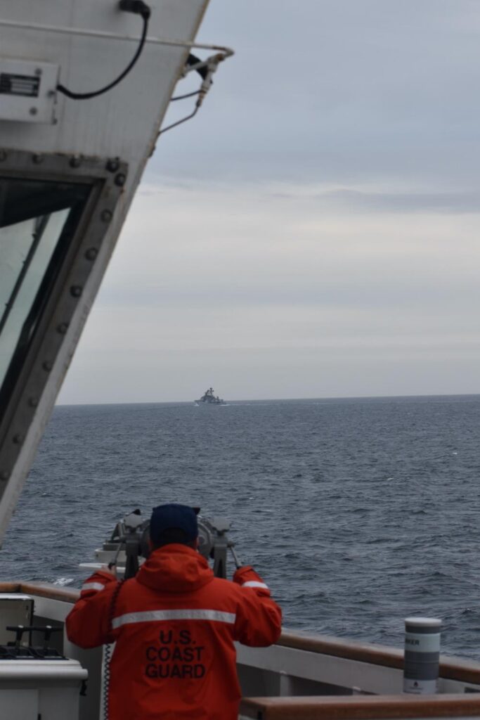 A Coast Guard Cutter Kimball crewmember observing a foreign vessel in the Bering Sea, September 19, 2022.