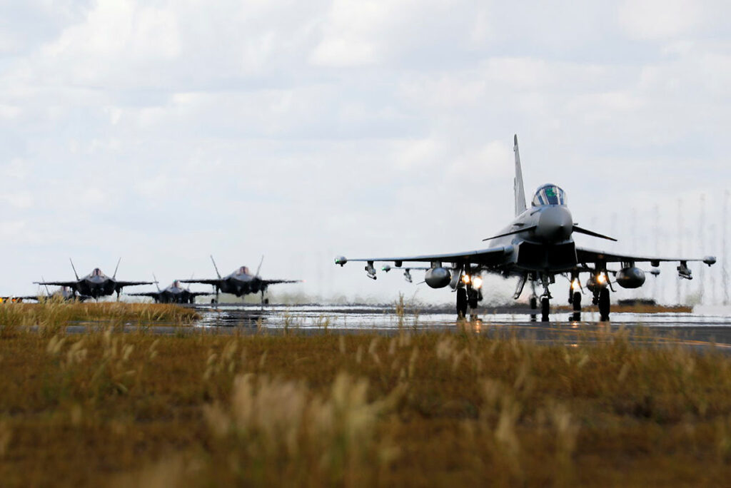 A Luftwaffe Air Force Eurofighter Typhoon taxis towards the runway with Royal Australian Air Force F-35A Lightning II aircraft following during Exercise Pitch Black 2022.