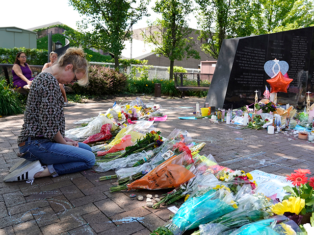A visitor prays at a memorial to the seven people killed and others injured in the Fourth of July mass shooting at the Highland Park War Memorial in Highland Park, Ill., Thursday, July 7, 2022. On Wednesday, July 27, 2022, Robert Crimo III was indicted by a grand jury on …
