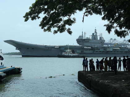 People watch the INS Vikrant leave for trials in the Arabian Sea in Kochi, India, July 2,