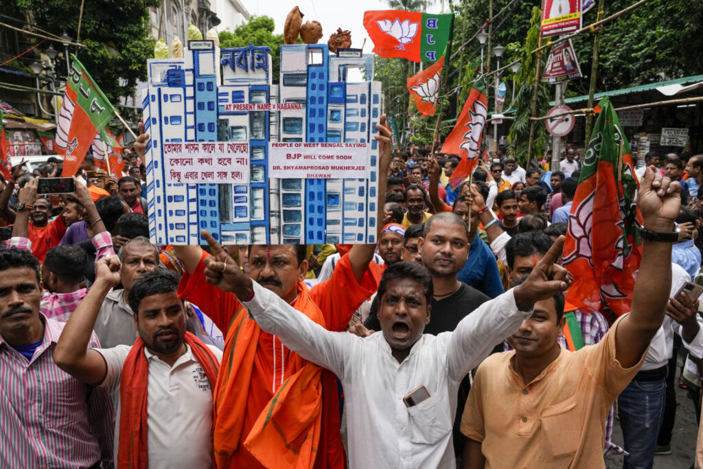 Bharatiya Janata Party (BJP) supporters march towards the state secretariat during a protest against alleged corruption by the West Bengal state ruling Trinamool Congress party leaders in Kolkata, India, Tuesday, Sept. 13, 2022. (AP Photo/Bikas Das)
