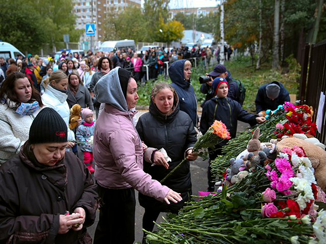 People gather to lay flowers, put toys and light candles in memory of victims of the shooting at school No. 88 in Izhevsk, Russia, Monday, Sept. 26, 2022. Authorities say a gunman has killed 15 people and wounded 24 others in a school in central Russia. According to officials, 11 …