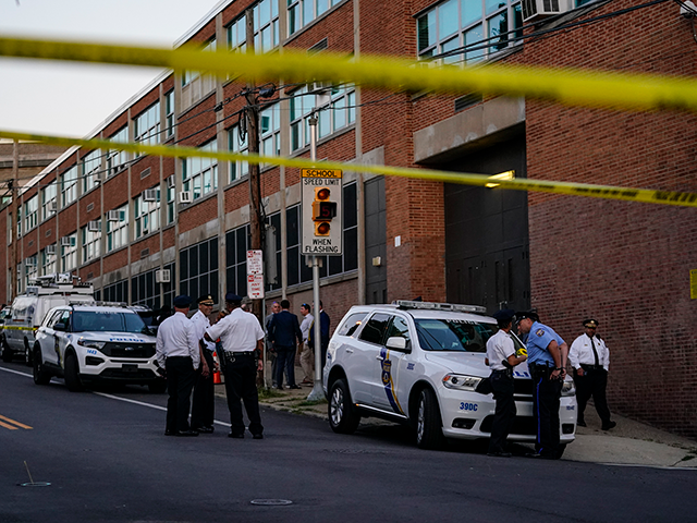 Investigators work the scene where multiple people were shot near a high school in Philadelphia, Tuesday, Sept. 27, 2022. (AP Photo/Matt Slocum)